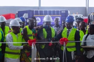 Dr. Joshua Makubu, Oti Regional Minister, cuts tape for the plant