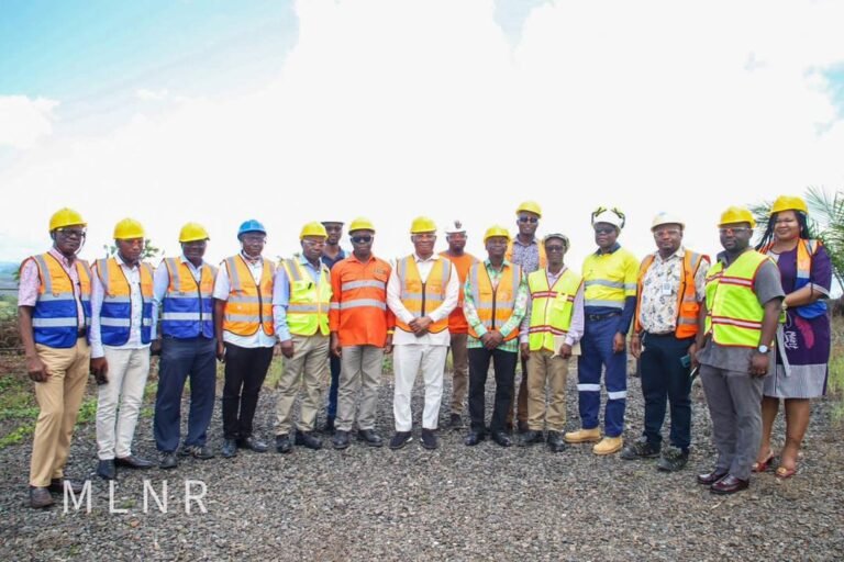 George Mireku Duker, Deputy Lands Minister, flanked by officers of the ministry and GMC workers