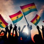 Silhouettes of People Holding Flag of Ghana